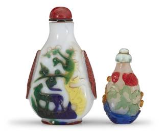 1151 Two Chinese overlay glass snuff bottles Qing Dynasty (1644-1912) or later Each multi-colored glass overlay, comprising one depicting a bird and a beast, the other cut with floral motifs 2 pieces Larger: 4.25" H x 2.625" W x 1.375" D; Smaller: 2.75" H x 1.5" W x 1.125" D Estimate: $1,000 - $1,500