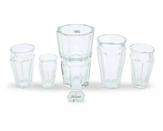 1390 A group of five Baccarat glass 'Edith' and 'Nelly' vases Late 20th century Each with etched factory mark Comprising one 'Edith' vase housed in original box, and four 'Nelly' vases in graduated sizes, the two middle-sized as a pair, together with a small Baccarat shelf display sign 6 pieces Edith: 9.875" H x 6.75" Dia.; Box: 11.5" H x 8.375" W x 8.25" D; Smallest vase: 5.125" H x 3.375" Dia. Estimate: $800 - $1,000