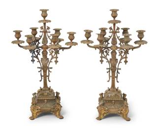 1194 A pair of Continental gilt bronze candelabra Late 19th century Each figural herm standard issuing seven lights, raised on an architectural base with griffons at corners with paw feet 2 pieces Each: 22" H x 13.25" W x 8.5" D Estimate: $700 - $900