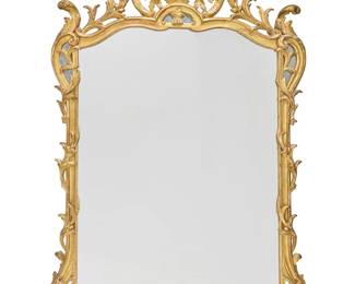 1071 A Rococo style giltwood mirror 19th/20th century With openwork foliate border crested by roses, the corners and crest with small mirrored panels 77.75" H x 49" W x 6.25" D Estimate: $1,000 - $2,000