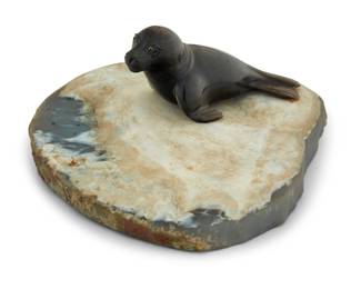 1250 A carved hardstone model of a seal Late 20th century With inset glass eyes, on a geode cross-section base Overall: 2.875" H x 7.25" W x 5.75" D Estimate: $400 - $600