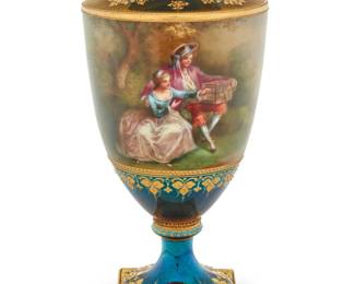 1214 A Vienna style porcelain urn Early 20th century With overglaze blue beehive mark to underside, and stamped in red: Germany / [crown above cipher]; inscribed: 2547 The body painted with a continuous bucolic figural landscape scene, the foot and base with gilt floral motifs on an iridescent turquoise ground 11" H x 5.25" Dia. Estimate: $500 - $700