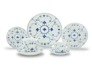1246 A Royal Copenhagen porcelain 'Blue Fluted Plain' dinner service 1950s/60s Each with green printed factory mark above underglaze blue wave and green painted pattern '1' over shape number Comprising: 22 dinner plates (10.25") 24 salad plates (7.625") 12 bread & butter plates (6.25") 31 cups (2.5" H x 3.875" W x 3" D) 21 saucers (5.375") 1 high-handled cup (4" H x 5.125" W x 4" D) with 1 saucer (6.875") 112 pieces Estimate: $500 - $700