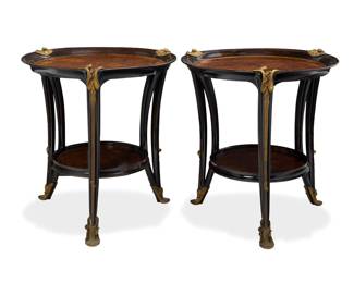 1117 Louis Majorelle (1859-1926) A pair of 'Aux Nenuphars' gueridons, circa 1900 Designed 1900-1905 Each Art Nouveau mahogany side table with circular burlwood veneer table top and undertier, featuring bronze mounts of water lilies at shoulders and feet on crescent open legs 2 pieces 32" H x 31" Dia. Estimate: $30,000 - $40,000