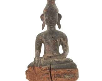 1158 A Laotian carved wood Buddha Late 19th/early 20th century Depicted with ushnisha flame and hands in bhumisparsha mudra 24.5" H x 11.25" W x 8.75" D Estimate: $300 - $500