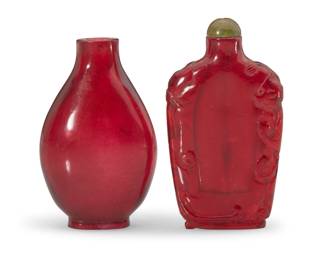 1152 Two Chinese red glass snuff bottles Qing Dynasty (1644-1912) or later Comprising one smooth and another carved with chilong figures at edges 2 pieces Chilong: 2.625" H x 1.625" W x 0.5" D; Smooth: 2.75" H x 1.625" W x 1" D Estimate: $1,000 - $1,500