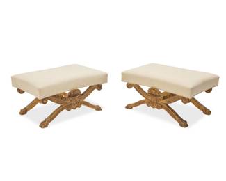 1051 A pair of George II style giltwood stools 20th century, after William Kent The upholstered seats each on X-form supports joined by a turned stretcher, carved with scrolled ends and paw feet 2 pieces Each: 19.75" H x 37.5" W x 25.5" D Estimate: $600 - $800