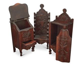 1054 Three Louis XV provincial style carved wood boissellerie 19th century Comprising a flour box decorated with wheat above a single drawer, a salt box with sliding front carved with fish and floral elements, and a knife holder depicting a basket and floral motifs, each with front hoof feet 3 pieces Tallest: 15.875" H x 6" W x 4.5" D; Widest: 15.5" H x 7.5" W x 6" D Estimate: $800 - $1,200