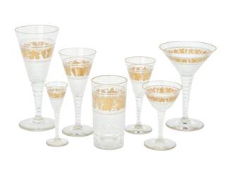1331 A Val St. Lambert parcel gilt glass 'Westminster' stemware service 1960s Each unmarked Comprising: 5 martini glasses (6.75") 7 sherbets (8.25") 10 tumblers (5.25") 8 claret wine glasses (6.75") 4 port wine glasses (6") 7 coupes (4.875") 1 cordial (4.875") 42 pieces Estimate: $1,200 - $1,800
