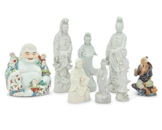 1033 An assembled group of twelve Chinese blanc de chine porcelain Guanyins 20th century Most with impressed maker's mark to underside or stamped: CHINA Together with an enameled porcelain Buddha and model of a fisherman 14 pieces Tallest Guanyin: 15" H x 5.125" W x 3.375" D; Smallest: 7.75" H x 4.25" W x 3.5" D Estimate: $2,000 - $3,000