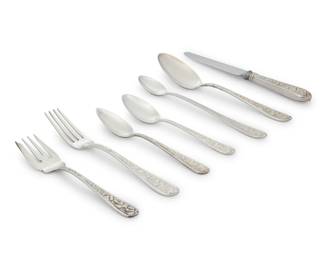 1227 An assembled Stieff sterling silver 'Corsage' part flatware service Late 20th century Designed 1935 Each marked for maker and sterling; some pieces monogrammed Comprising: 18 luncheon knives (8.875") 18 luncheon forks (7") 14 salad forks (6") 15 teaspoons (6") 8 five o'clock teaspoons (5.5") 8 iced tea spoons (7.5") 6 grapefruit spoons (6") 2 serving spoons (7.75") Together with 16 associated Stieff 'Repousse' forks, spoons, and serving pieces 105 pieces Total weighable sterling: 104.1 oz. troy approximately Estimate: $3,000 - $5,000