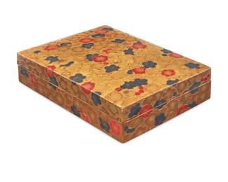 1099 A Japanese maki-e lacquer suzuribako calligraphy box Meiji Era (1868-1912) Each interior box inscribed for its contents The gilt and pigmented lacquer box exterior decorated with floral motifs in low relief, opening to reveal four smaller lidded boxes, one decorated with koi fish, another with sayagata pattern, another mounted with mother of pearl fans, and the last depicting gilt wildflowers and mounted with mother of pearl accents, each painted with faux side-stitch binding at one long edge and with gold and silver flakes to interior Overall: 1.5" H x 5" W x 4" D; Each inner box: 0.875" H x 2.375" W x 1.75" D Estimate: $3,000 - $5,000