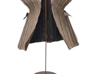 1159 An Indonesian metal armor vest Late 19th/early 20th century; Nias Island Raised on a metal stand Armor: 24" H x 25" W x 18" D; Stand: 36" H x 20" W x 12" D Estimate: $800 - $1,200