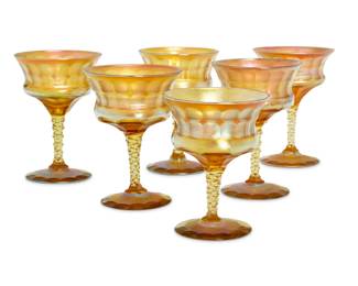 1104 Six Tiffany cut Favrile glass goblets Early 20th century Each etched: L.C.T. / Favrile / J 1197 6 pieces Largest: 5" H x 3.75" Dia.; Shortest: 4.625" H x 3.5" Dia. Estimate: $600 - $800