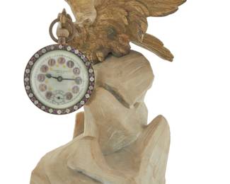 1305 A Continental gilt bronze and marble pocket watch holder Early 20th century Clock dial marked: Camerden & Forster / New York / MADE IN FRANCE Together with a French single-movement clock with cut glass jewels mounted to dial, bearing Arabic numerals in guilloché cartouches, with seconds subsidiary dial Holder: 11.25" H x 9.75" W x 7.25" D; Clock: 3.375" H x 3.125" W x 3" D Estimate: $1,000 - $1,500