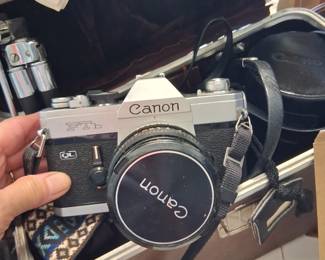 Vintage Canon camera outfit, lenses and tripod and flash and strap included in case