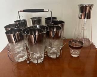 vintage Mid-Century Modern Dorothy Thorpe silver fade bar set with a chrome caddy