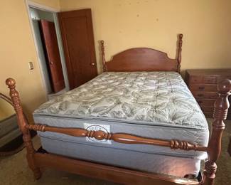 Queen size four-poster bed frame featuring carved finials