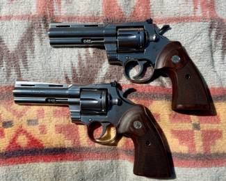 Exceptional pair of Colt Python .357 Magnum revolvers, stainless steel with 4.25" barrels and factory wood grips. Highly sought-after modern Colts with original cases. A fantastic opportunity for collectors, enthusiasts, or investors to acquire a matching pair of iconic Colt Pythons.