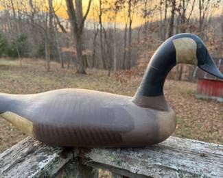 Hand-carved Canada goose decoy with classic early-to-mid 20th-century form. Solid wood construction with carved wing detail, painted surface, and naturally worn patina from age and use. Strong folk character with pleasing proportions and an honest, untouched surface. Ideal for cabin, lodge, or Americana display, and appealing to both decoy collectors and folk art enthusiasts. Keywords / SEO tags Antique duck decoy, Canada goose decoy, carved wooden decoy, folk art decoy, hunting decoy, vintage waterfowl decoy, Americana folk art, cabin decor, lodge decor, sporting art, primitive folk art, hand carved bird, decoy carving, rustic decor, old decoy, collectible decoy, early decoy, wooden goose