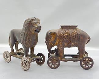 Lot #8 -Antique Cast Iron Elephant and Lion still banks on Wheels