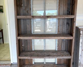 This rustic display cabinet features windows in the back for dimensional display 