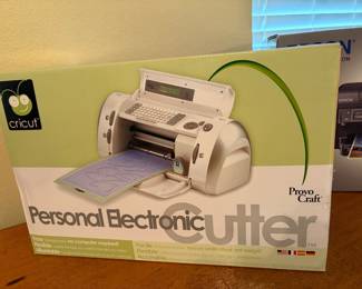 New in box! Personal Electronic Cutter The Cricut Personal Electronic Cutter is an original, cartridge-based die-cutting machine released by Provo Craft. Designed as a standalone system, it requires no computer or internet to operate. It precisely cuts letters, numbers, and shapes out of paper, cardstock, vellum, and vinyl for scrapbooking and crafts