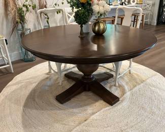 ARHAUS Asolo Brown dining table featuring a darkwood finish and a solid pedestal base
