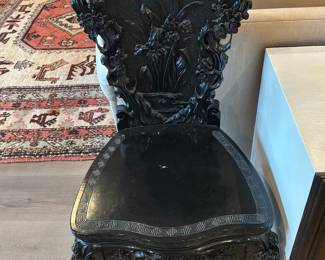 Antique Japanese dark Wood side chair featuring intricate relief carvings of plant motif a carved dragon chair