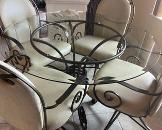 Kitchenette, wrought iron, glass top, four chairs with wheels