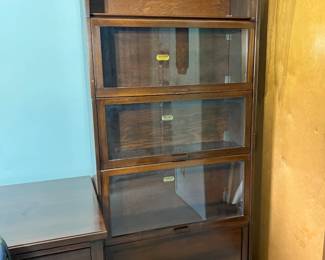 An exceptional antique solid wood five-tier sectional barrister bookcase manufactured by the legendary C. J. Lundstrom Mfg. Co.