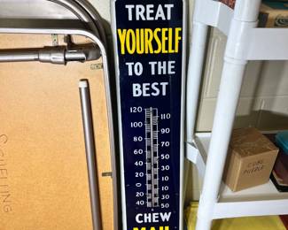 Advertising thermometer sign reading "Treat Yourself to the Best / Chew Mail Pouch Tobacco"