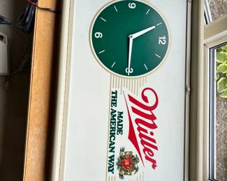 A fantastic retro 1970s light-up rectangular wall clock advertising Miller Beer: Made the American Way with a green clock face.