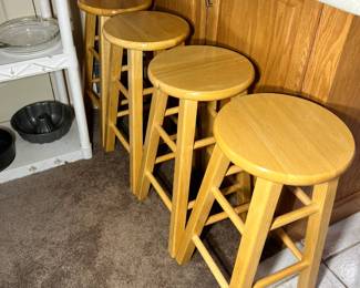 Four matching wooden stools