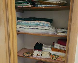 Many table cloths, plastic and linen,  round & rectangular, plain & holiday towels, aome brand new