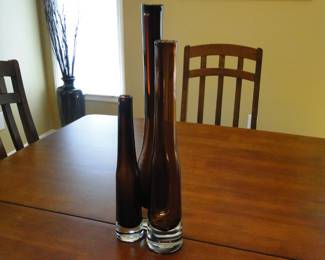Tall glass bottles, root beer colored