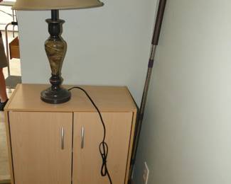 A stick on the right, a cabinet in the middle, and topped off with a lamp