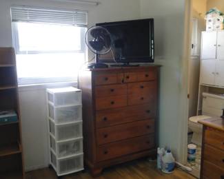 Plastic storage unit, dresser, with a fan and TV on top