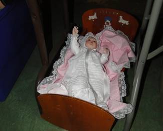 Vintage doll in vintage cradle