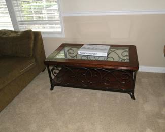 Glass top table, with solid wood trim and metal accents