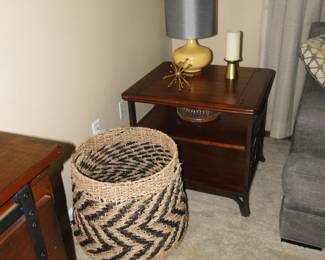 Large decorative basket, solid wood end table, some decorative items, and a nice yellow lamp