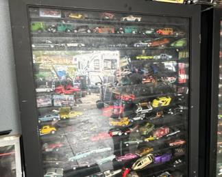 Collection of Die-Cast Model Cars in a Black Display Case