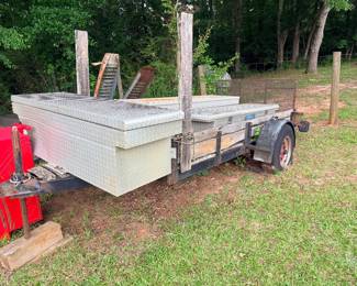 Trailer with one attached toolbox. Flooring needs replacing and tires replaced as well