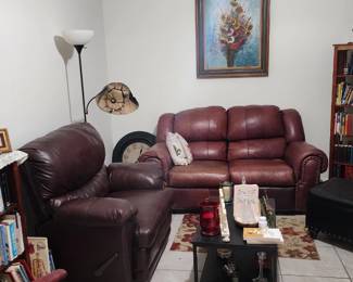 Comfortable burgundy reclining loveseat and matching oversized recliner chair. Both recline smoothly and are very comfortable. Classic rolled-arm style with nailhead trim accents. Solid, heavy pieces with lots of life left. Some visible wear on loveseat seating cushions consistent with normal use, reflected in price. Great setup for cabin, den, movie room, or family room. Living room furniture sold individually or as a set. Love seat: $395, Chair $295