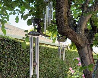 Decorative Wind Chimes with Ornate Top Pieces and Bell-Shaped Bottom Accent