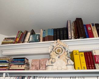 Collection of Religious Books and Decorative Cherub Clock
