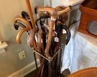 Canes, Walking Sticks and Vintage Umbrellas in a Brass Stand.