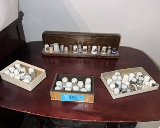 A collection of thimbles. Many of these are royal bone china, from England, Japan, and Canada. Others have no maker marks, and are just cute.