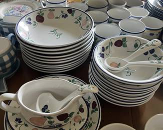 A matching set of dishware, decorated with a fruit print.