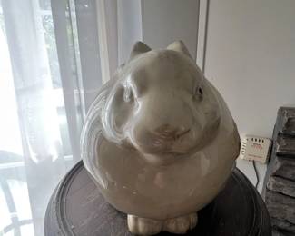 Rotund ceramic bunny statue.